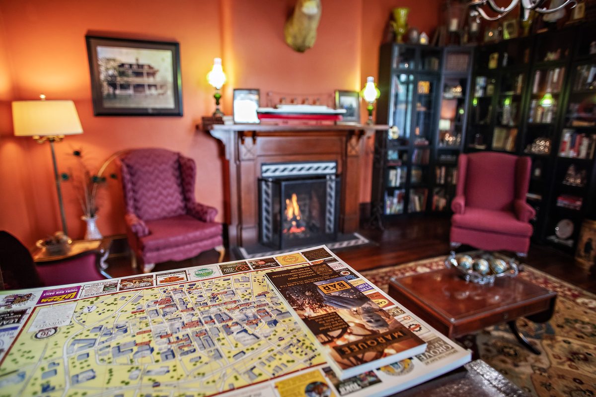 Asheville area map spread out on the parlor table at The Reynolds Mansion — guests plan their day by the fire with local recommendations from the innkeeper