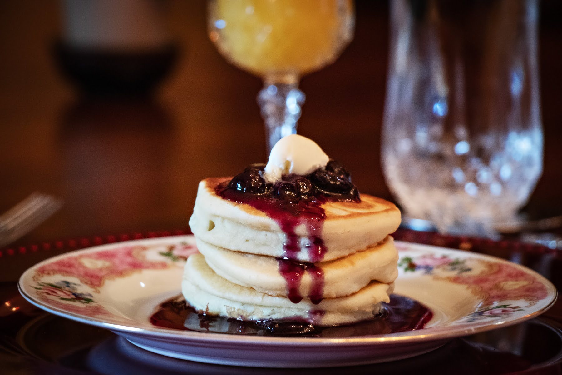 Fourth course — blueberry pancake stack with warm compote and butter