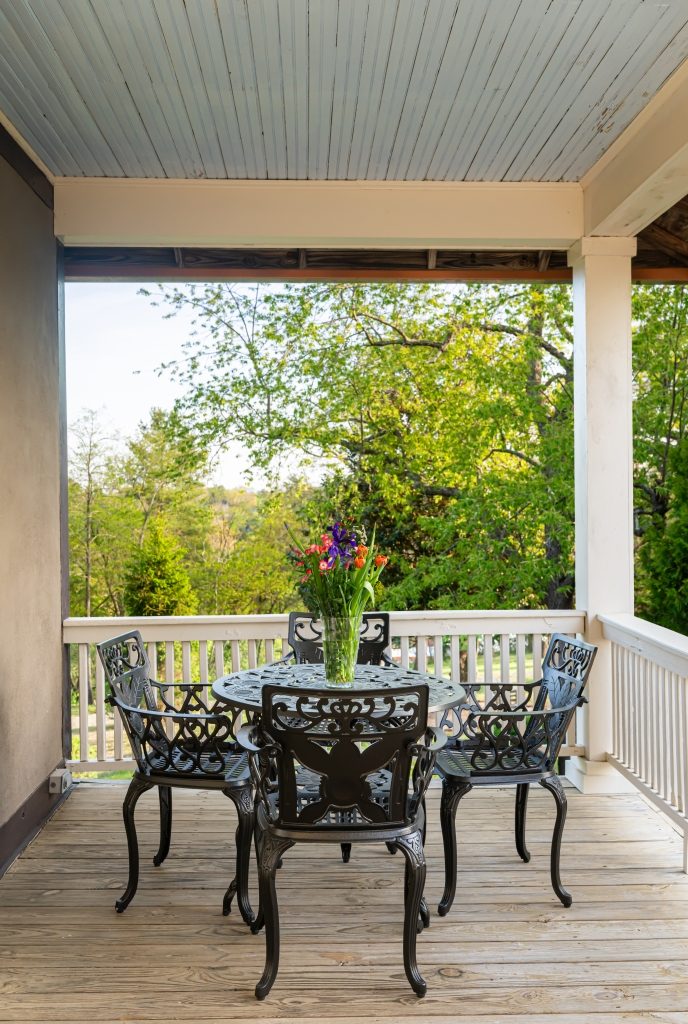 Carriage House porch bistro table with mountain view at The Reynolds Mansion