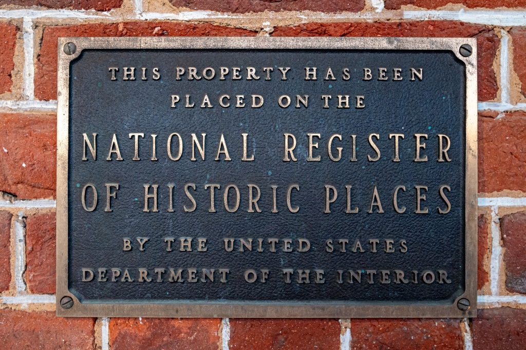 National Register of Historic Places plaque mounted on the original 1847 brick exterior of The Reynolds Mansion