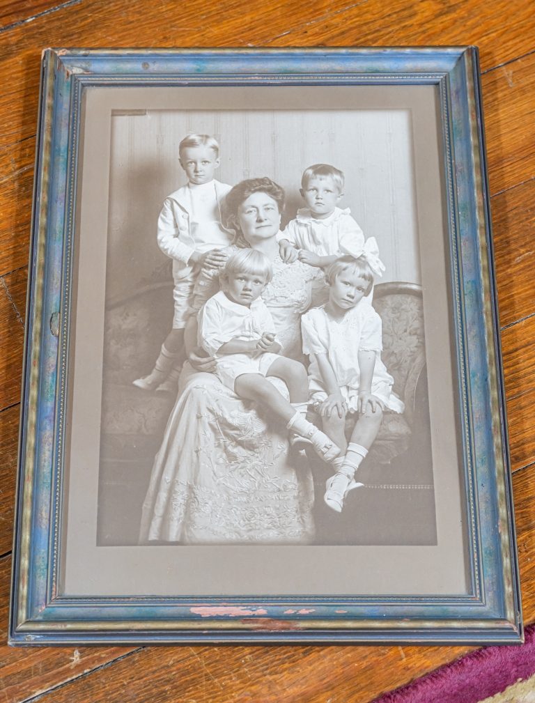 A Reynolds family portrait displayed at The Reynolds Mansion — a mother and four children in formal attire, early 1900s