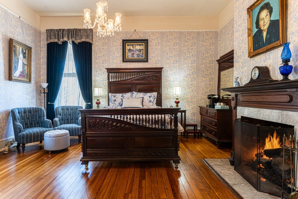 Lila guest room with fireplace at The Reynolds Mansion