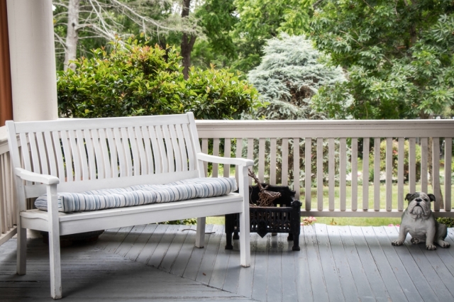 The wraparound porch at The Reynolds Mansion — rocking chairs, mountain views, and the kind of morning you want to give someone you love