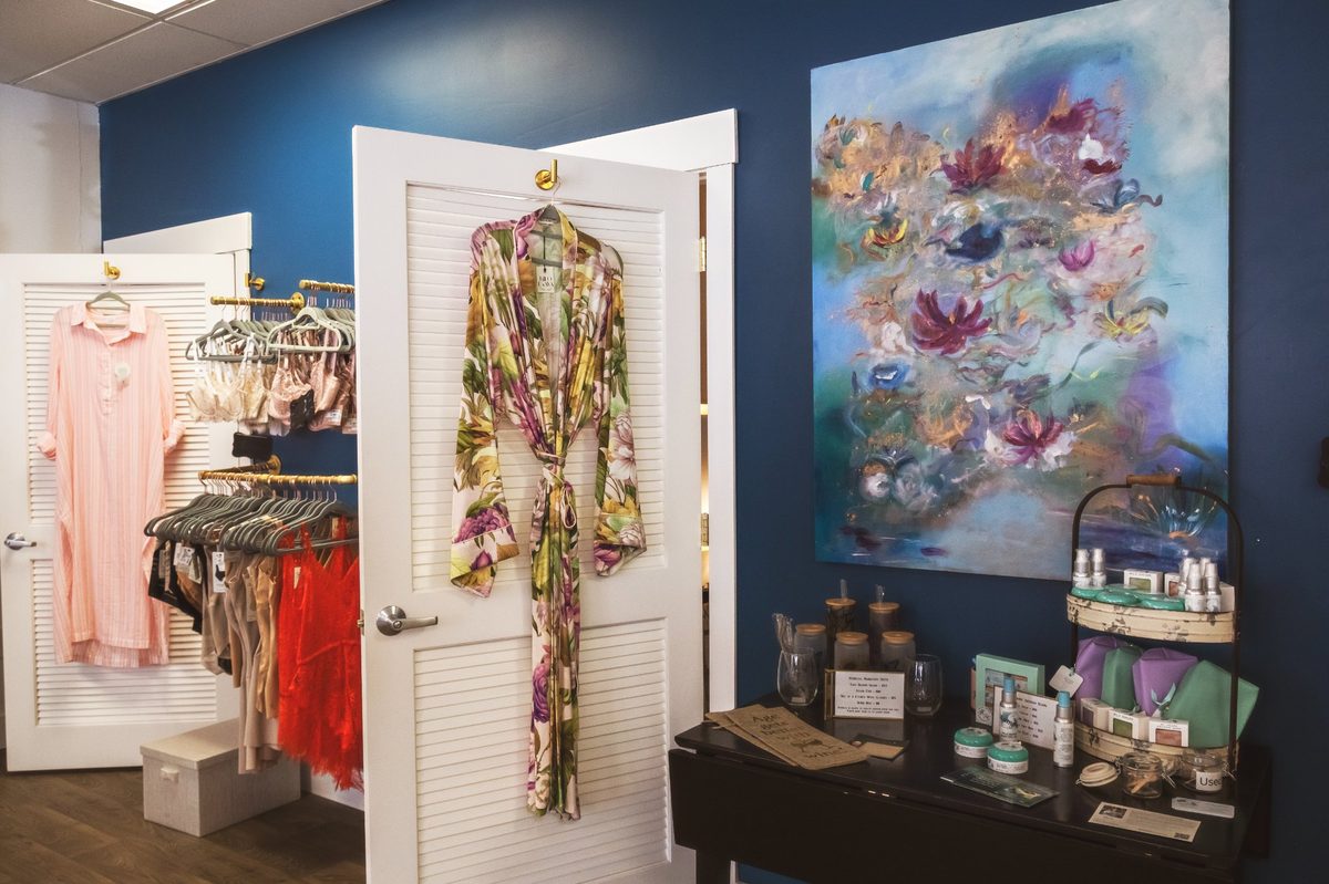 Hello Gorgeous boutique interior — robes, lingerie, local art, and curated skincare products