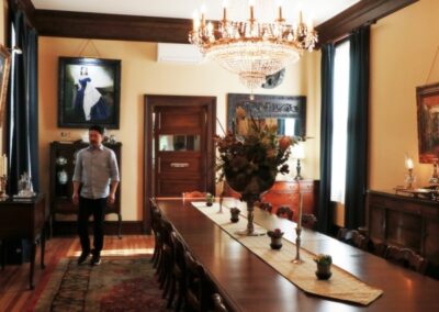 A man standing in front of a table in a room.