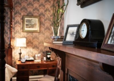 A living room with a fireplace and a clock on the mantle